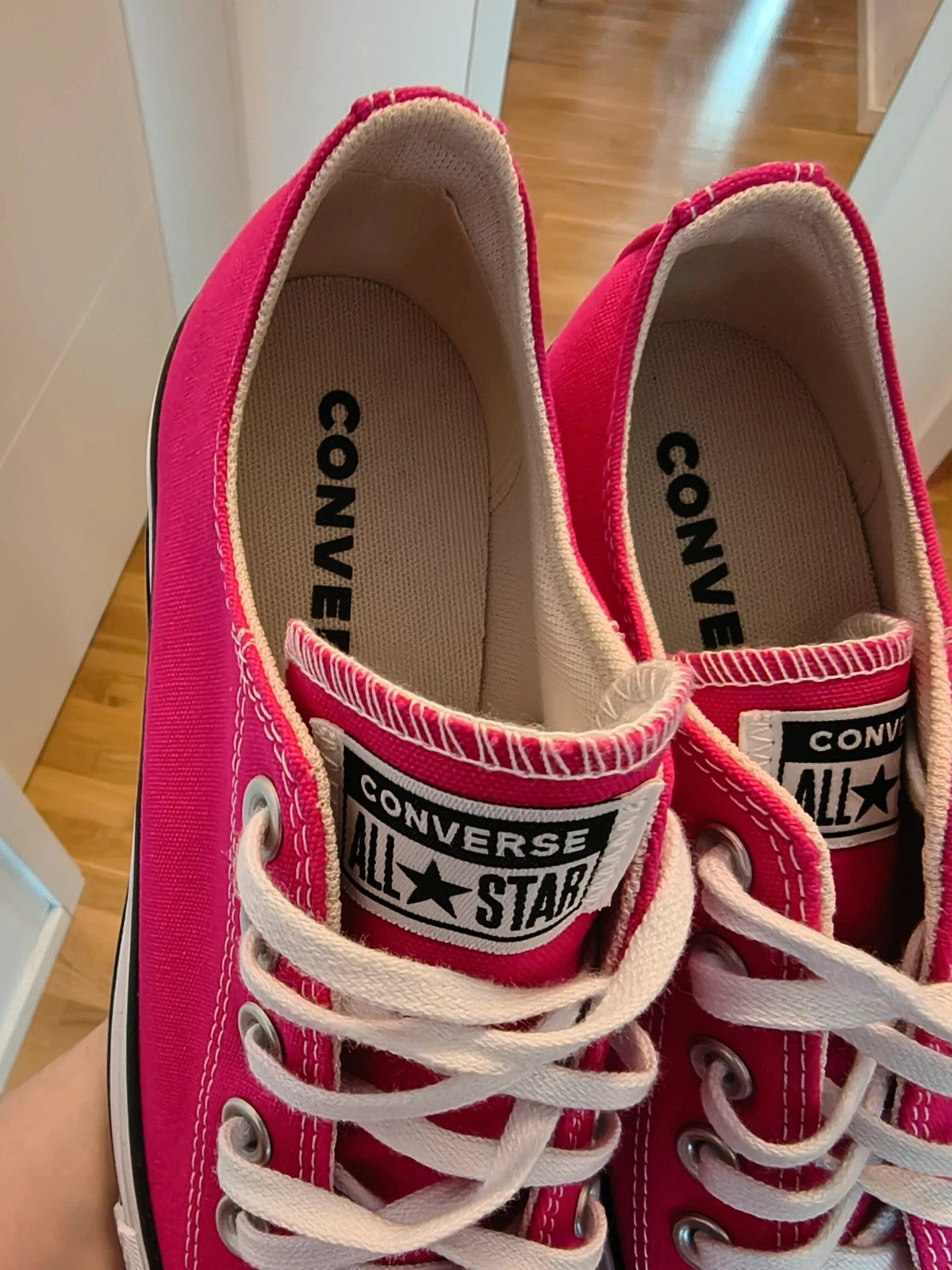 Converse pink Chuck Taylor All Star Lift Platform sneakers with white sole and logo.