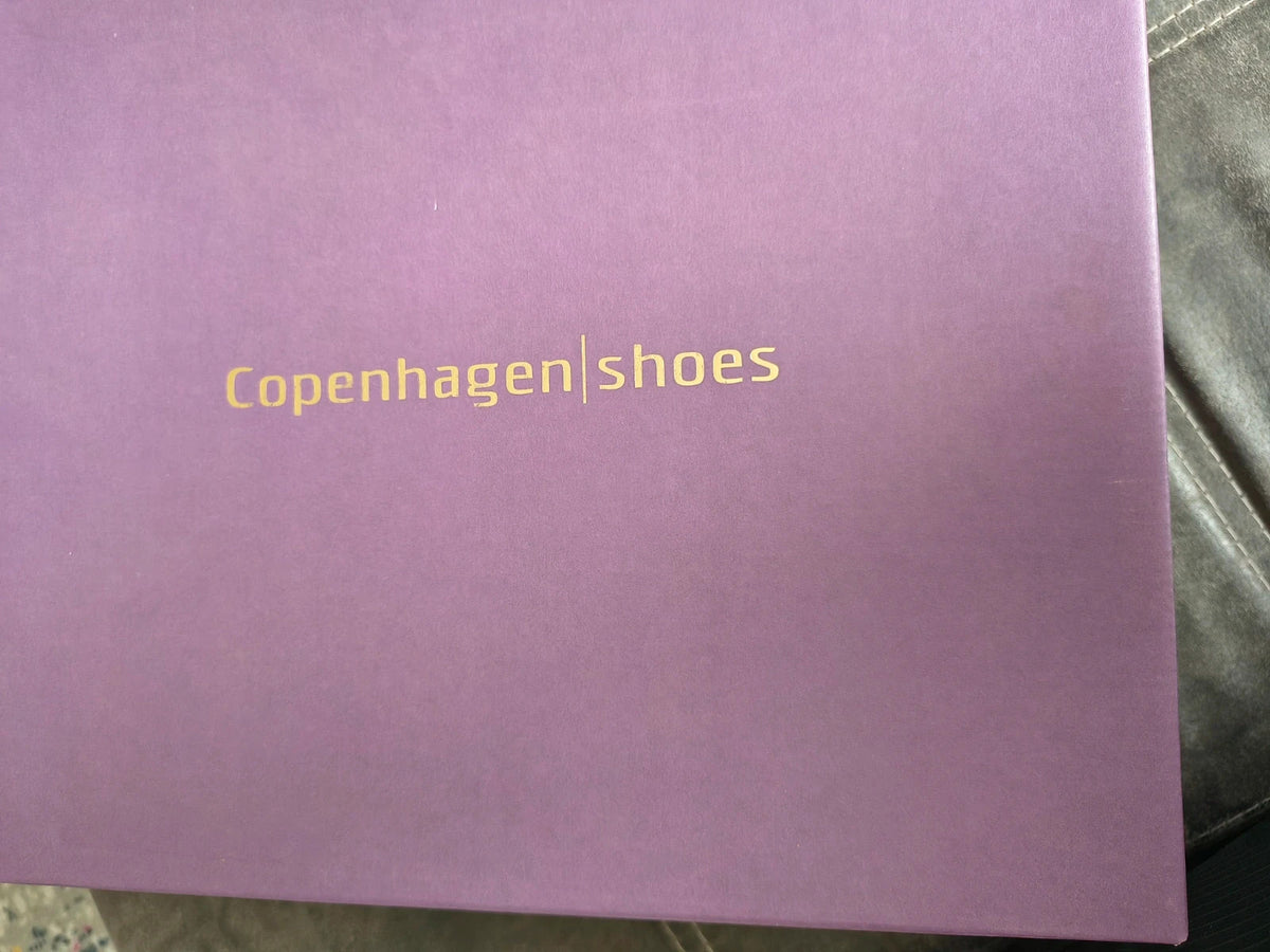 Copenhagen Shoes black and green leather Chelsea boots with crocodile pattern and elastic side inserts.