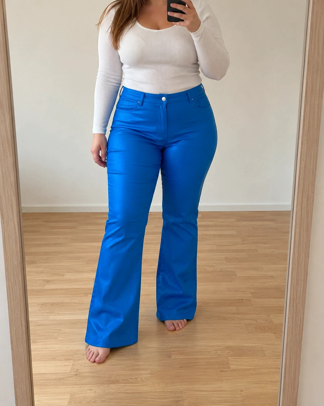 Bootcut blue bootcut trousers with shiny finish, fitted hips, and flared legs.