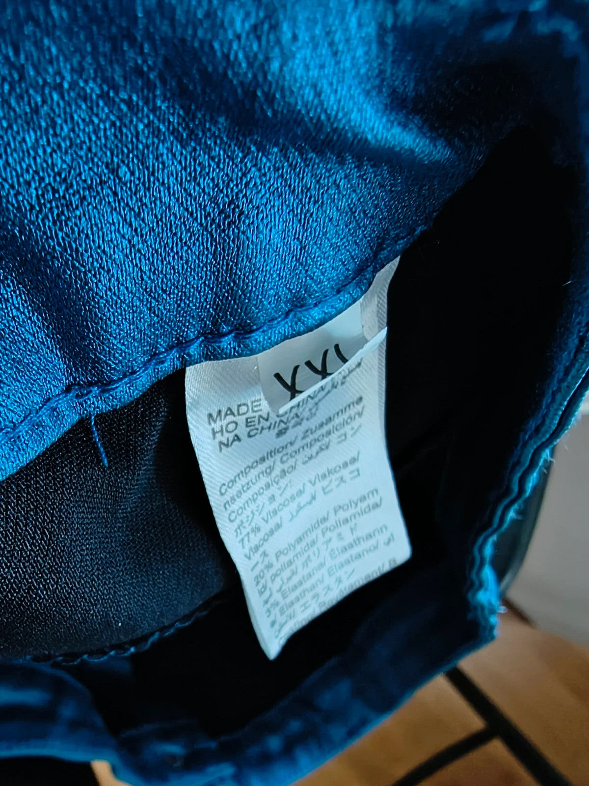 Bootcut blue bootcut trousers with shiny finish, fitted hips, and flared legs.