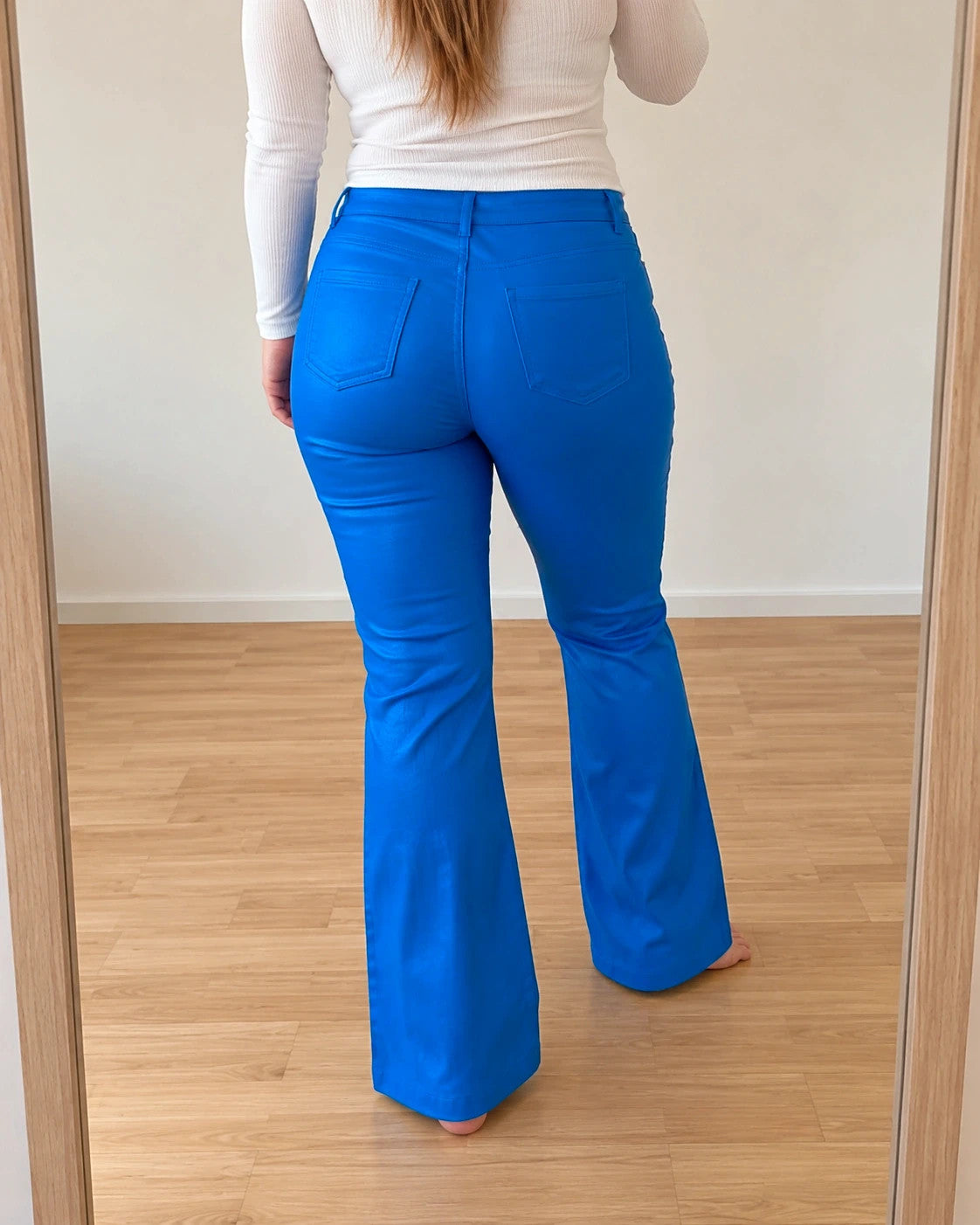 Bootcut blue bootcut trousers with shiny finish, fitted hips, and flared legs.