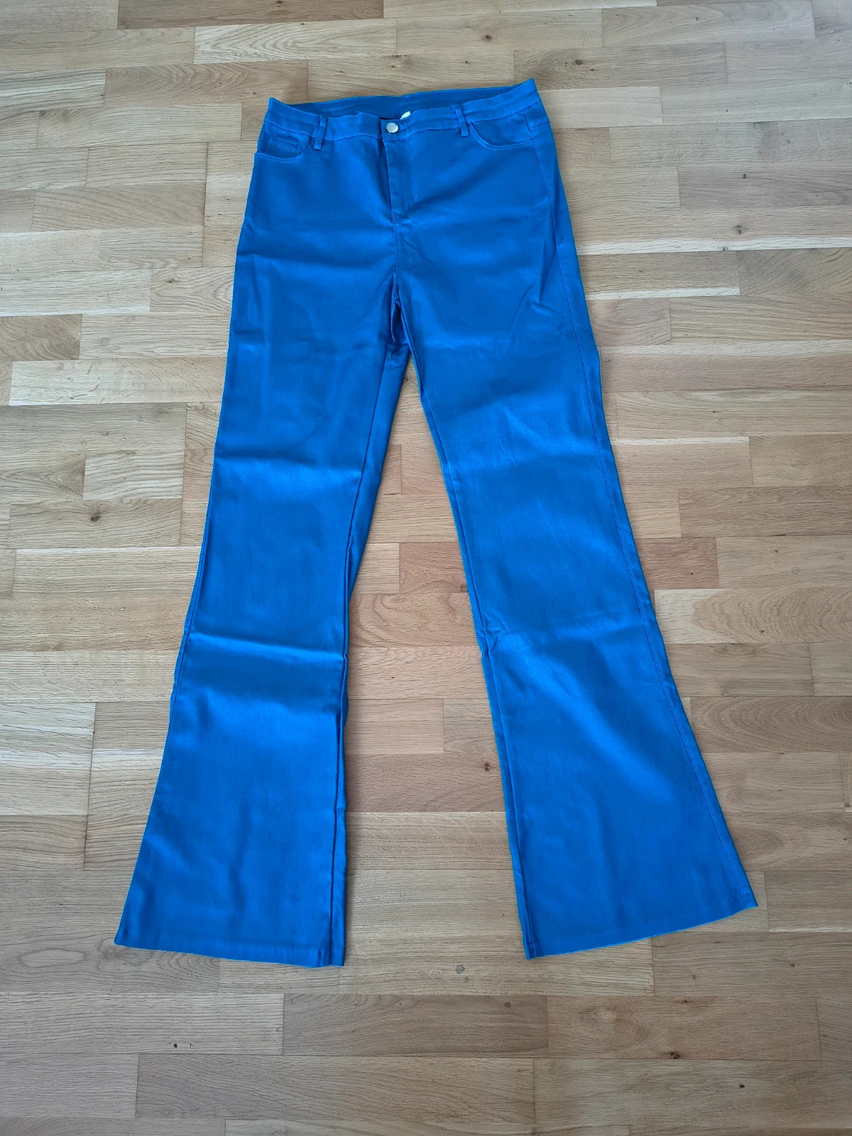 Bootcut blue bootcut trousers with shiny finish, fitted hips, and flared legs.