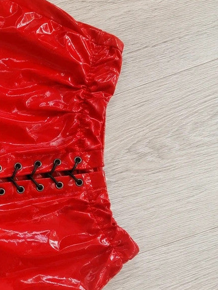 Red pajama shorts with shiny wet look and black lace-up detail.