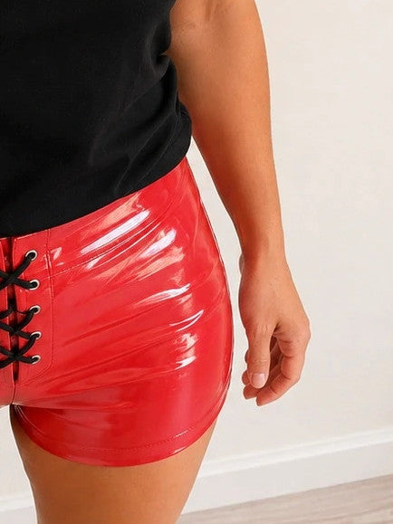 Red pajama shorts with shiny wet look and black lace-up detail.