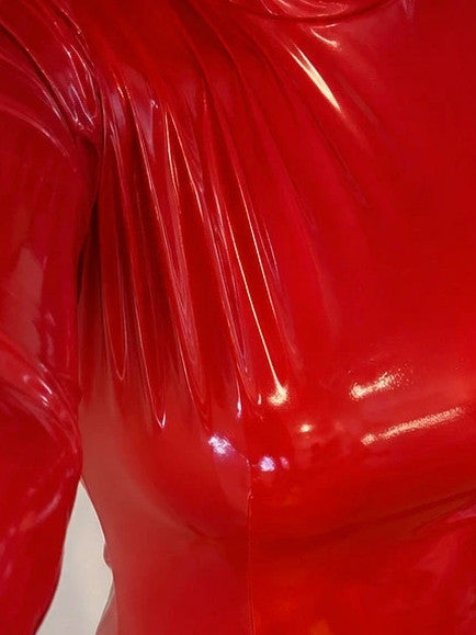 Red bandage dress with wetlook finish, standing collar, and long sleeves.