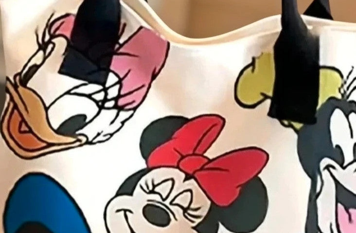 Cartoon cream shopping tote featuring Goofy design and synthetic material.