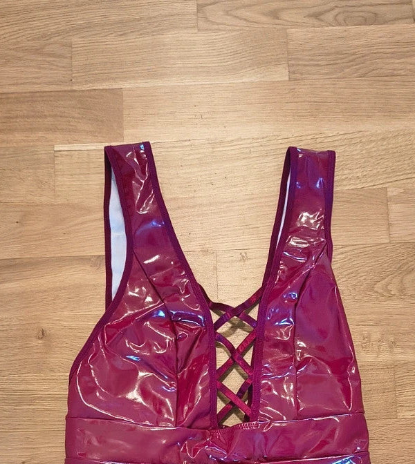 Bordeaux burgundy bandage dress with lace-up detail and glossy vinyl appearance.