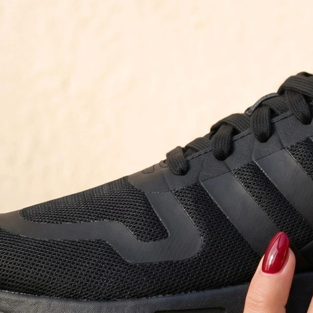 Adidas black trainers with synthetic and textile material, classic design, original box included.