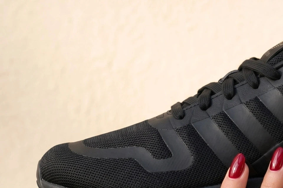 Adidas black trainers with synthetic and textile material, classic design, original box included.