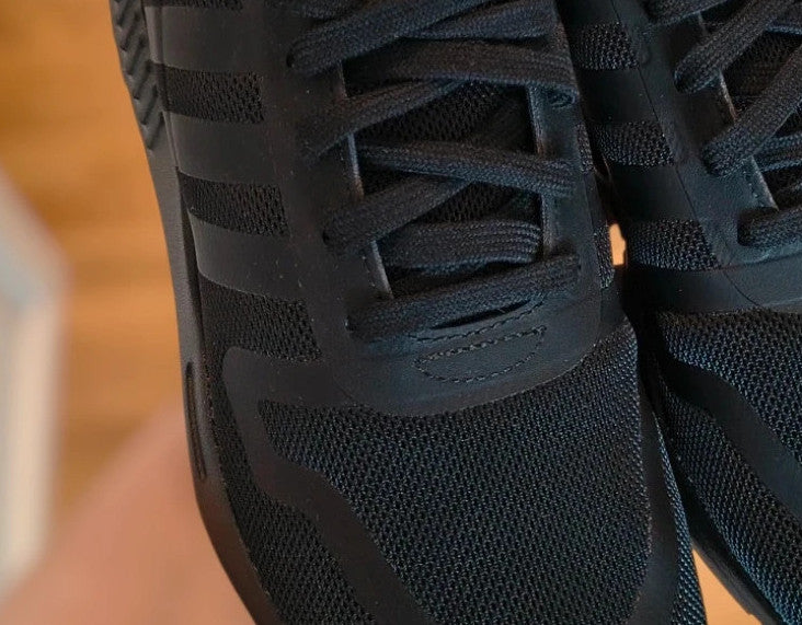 Adidas black trainers with synthetic and textile material, classic design, original box included.