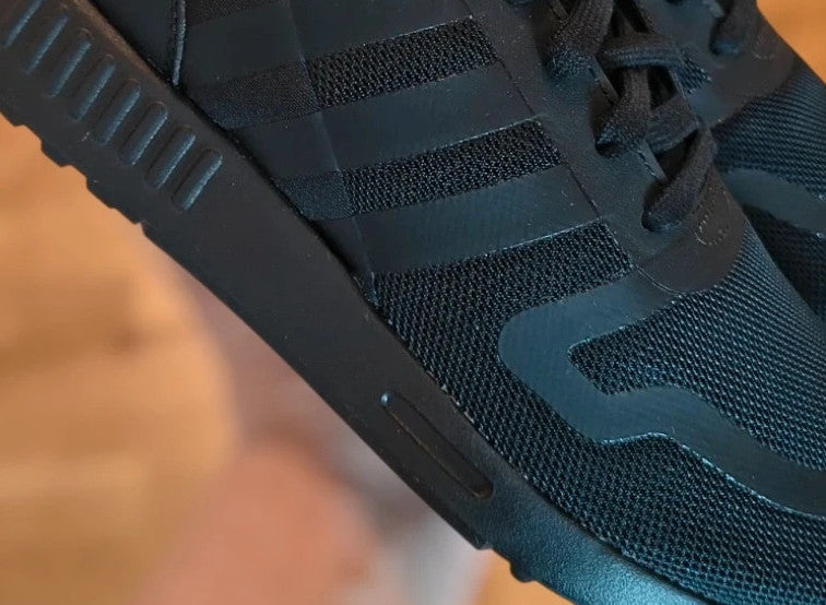 Adidas black trainers with synthetic and textile material, classic design, original box included.