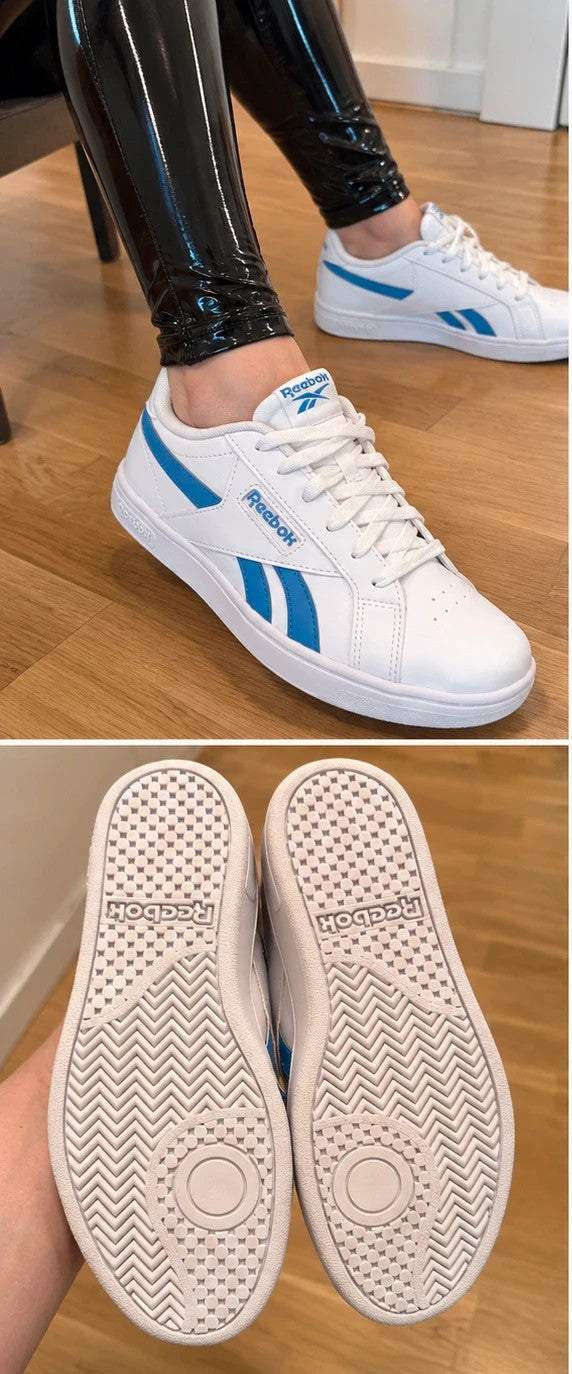 Reebok kids trainers white with blue details, classic lace-up design, synthetic material.