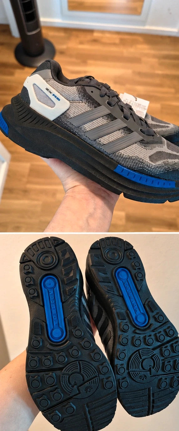Adidas trainers grey black with blue accents, sporty design and distinctive sole.