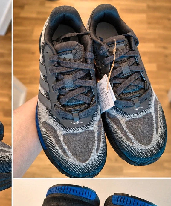 Adidas trainers grey black with blue accents, sporty design and distinctive sole.
