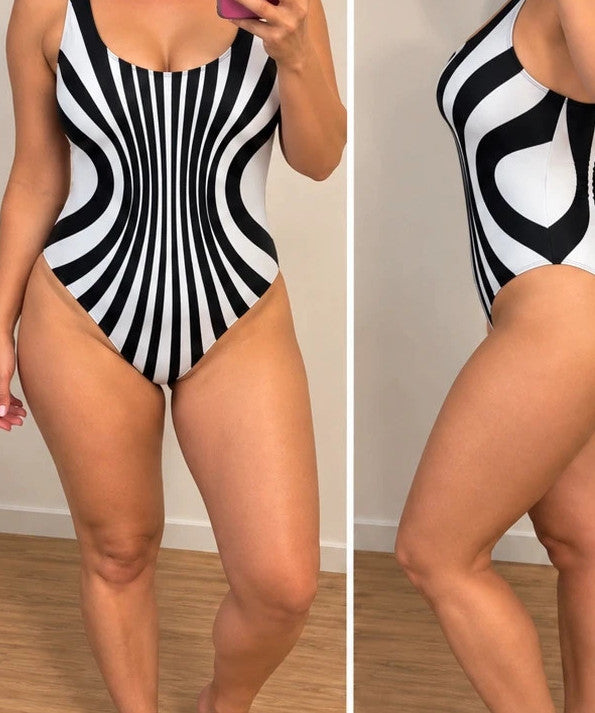Muster one-piece swimsuit black and white with bold striped pattern and deep back cut.