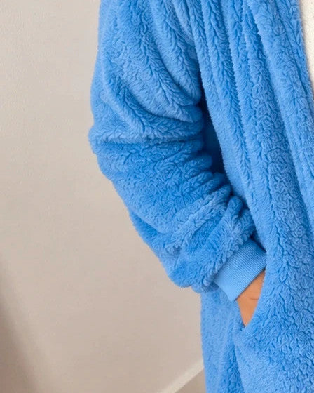 Outfit blue loungewear set, fluffy teddy material, includes shorts, top, and hooded jacket.