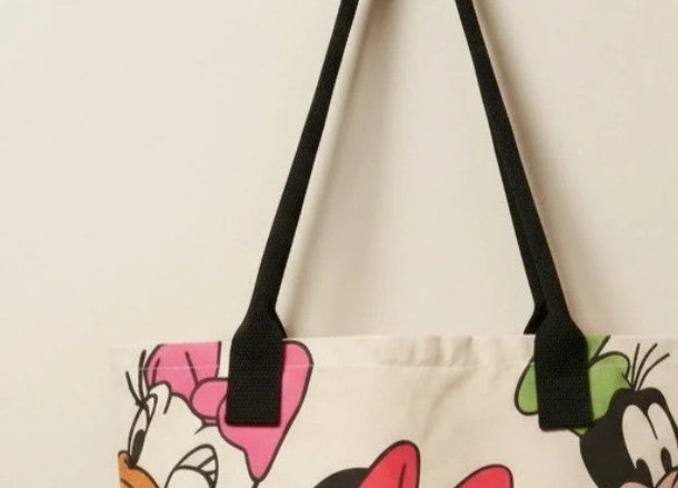 Kleine Tasche cream shopping tote with colorful cartoon comic print and sturdy handles.