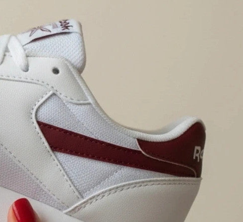 Reebok white trainers with synthetic and textile materials, featuring classic design elements.