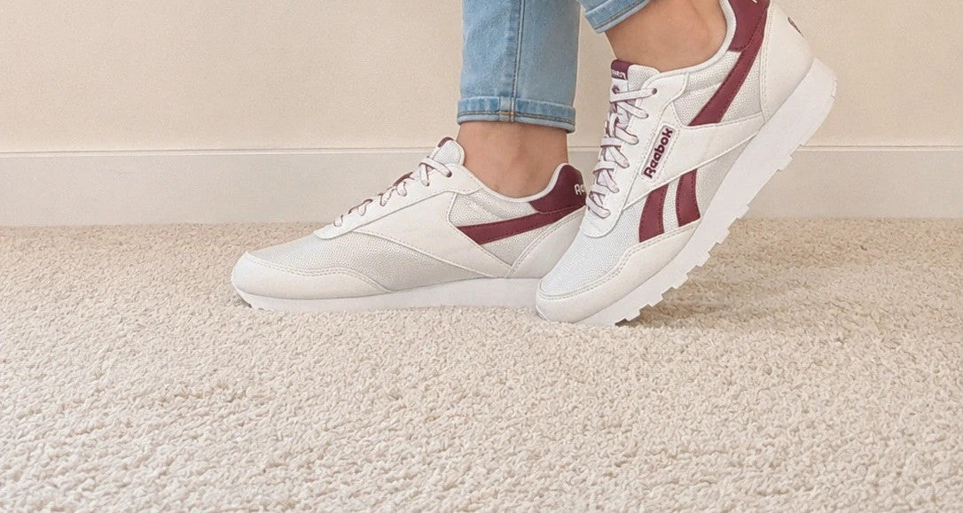 Reebok white trainers with synthetic and textile materials, featuring classic design elements.