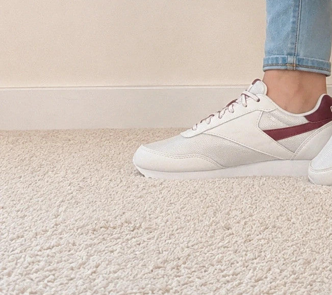 Reebok white trainers with synthetic and textile materials, featuring classic design elements.