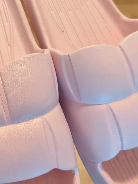 Slipper pink slides lightweight synthetic foam material with casual design.