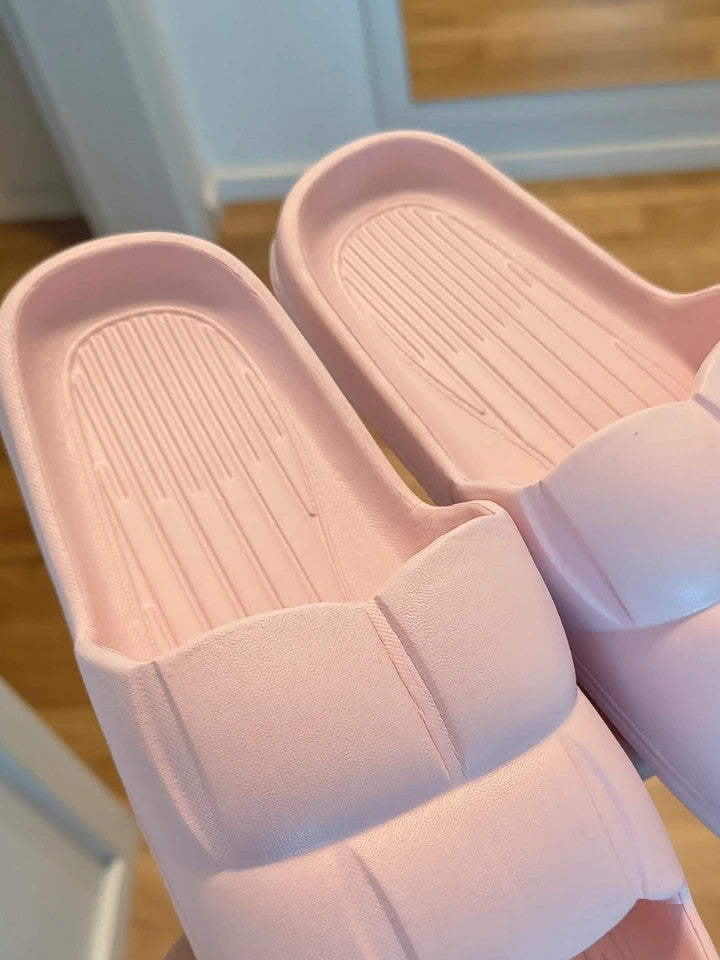 Slipper pink slides lightweight synthetic foam material with casual design.
