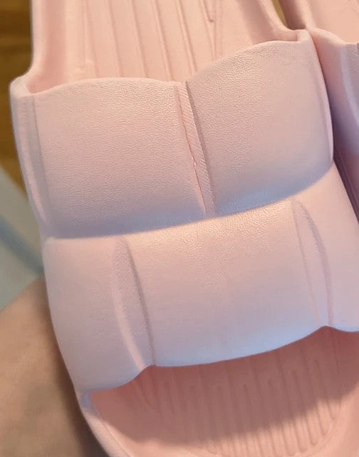 Slipper pink slides lightweight synthetic foam material with casual design.