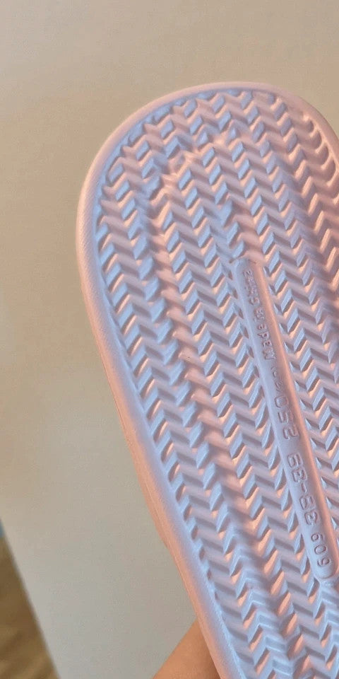 Slipper pink slides lightweight synthetic foam material with casual design.