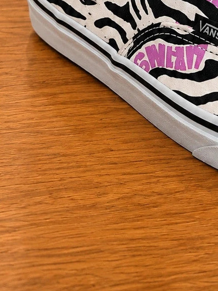 VANS trainers black white zebra print with pink logo and black laces.