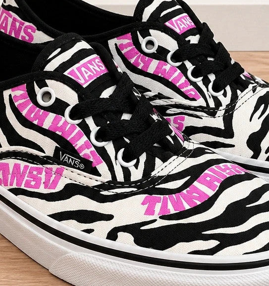 VANS trainers black white zebra print with pink logo and black laces.