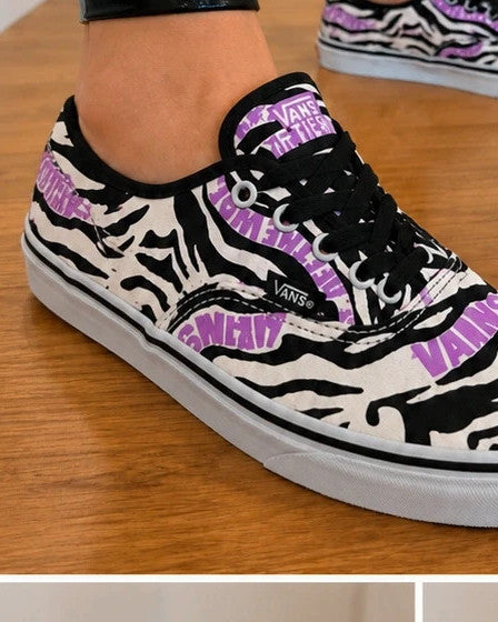 VANS trainers black white zebra print with pink logo and black laces.