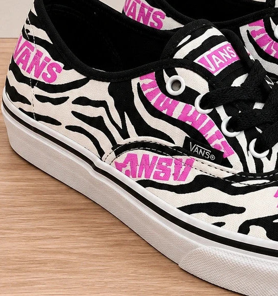 VANS trainers black white zebra print with pink logo and black laces.
