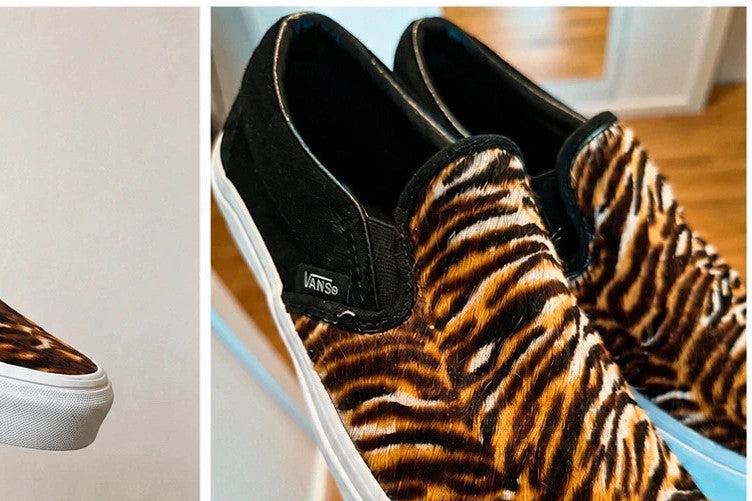 VANS Classic Slip-On sneakers black and brown soft suede with tiger pattern and white sole.