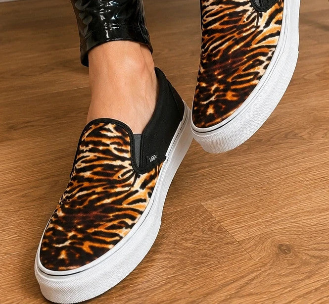 VANS Classic Slip-On sneakers black and brown soft suede with tiger pattern and white sole.