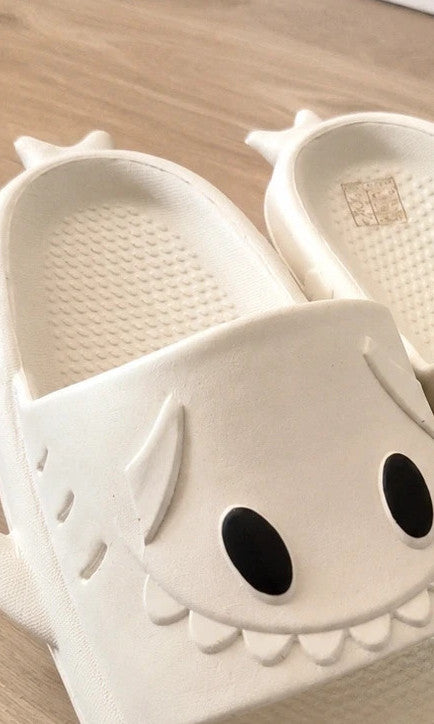 Perfekt cream slippers with monster design, featuring playful face and lightweight material.