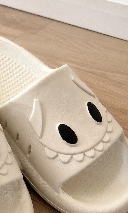 Perfekt cream slippers with monster design, featuring playful face and lightweight material.