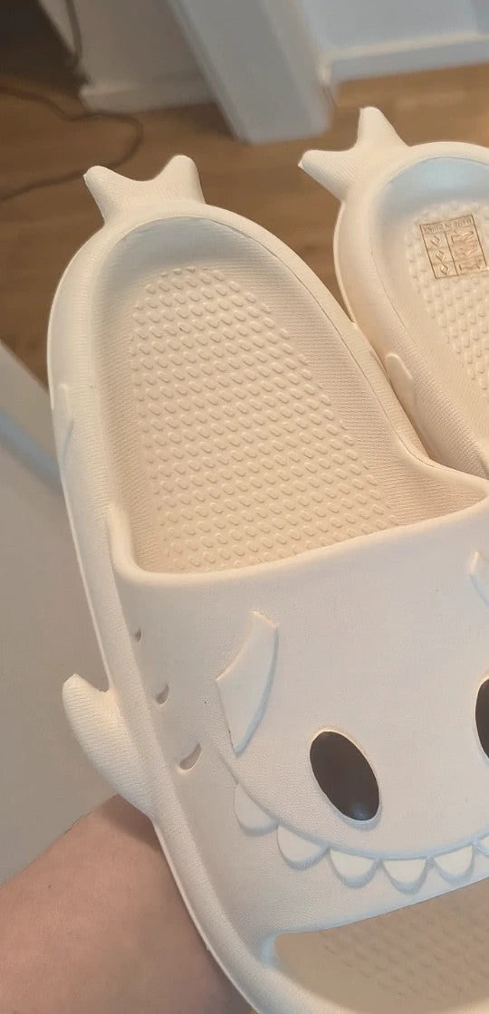 Perfekt cream slippers with monster design, featuring playful face and lightweight material.