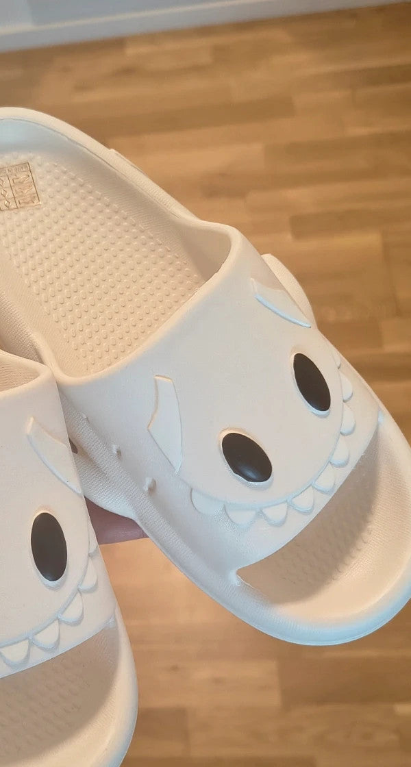 Perfekt cream slippers with monster design, featuring playful face and lightweight material.