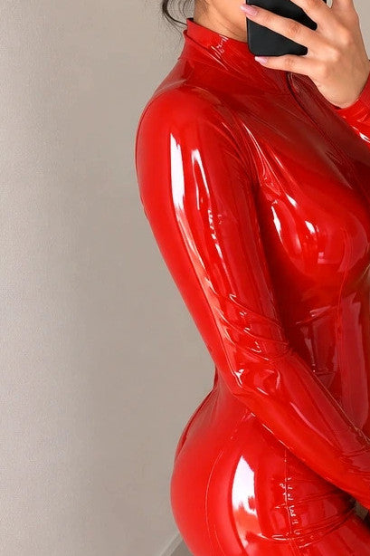 REI red jumpsuit shiny wetlook finish with front zipper and high collar.
