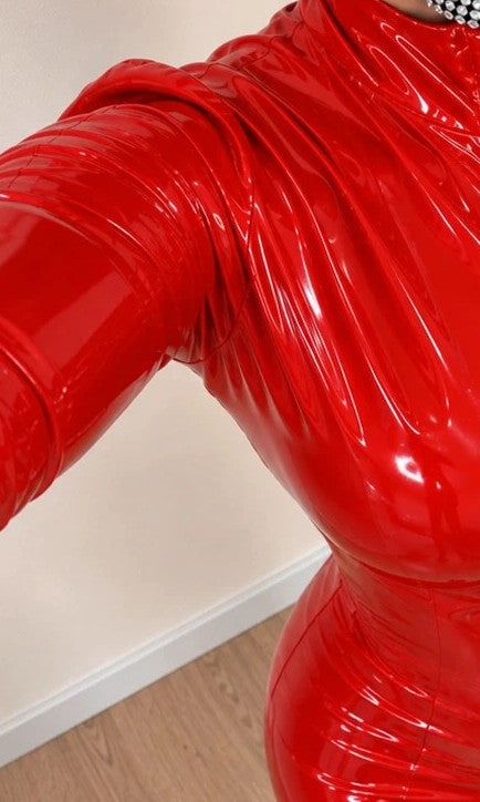 REI red jumpsuit shiny wetlook finish with front zipper and high collar.