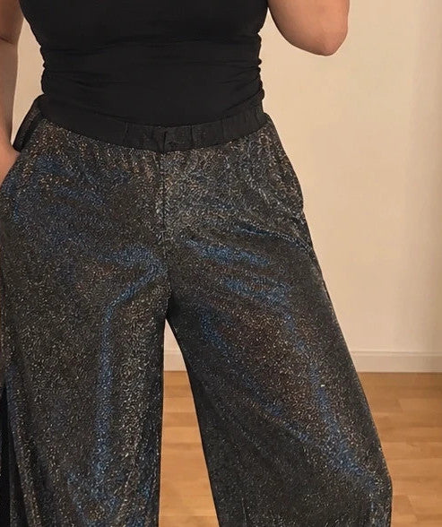 SheIn black and silver glitter flared pants with side slits and shimmering fabric.