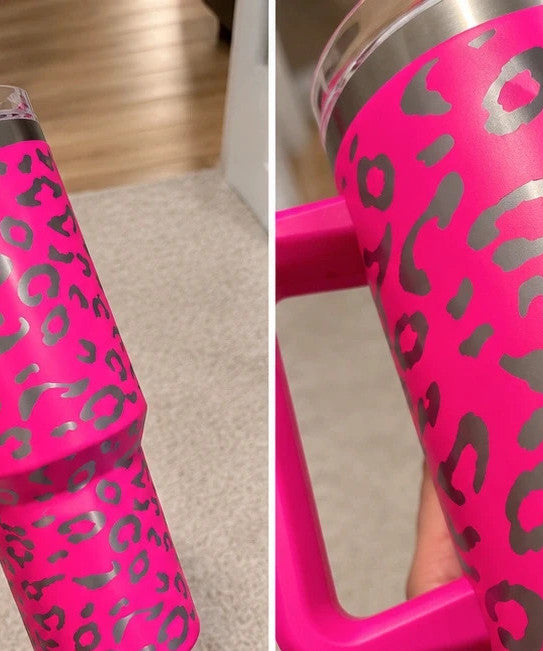 Pink tumbler with leopard print design, insulated, featuring handle and matching lid.