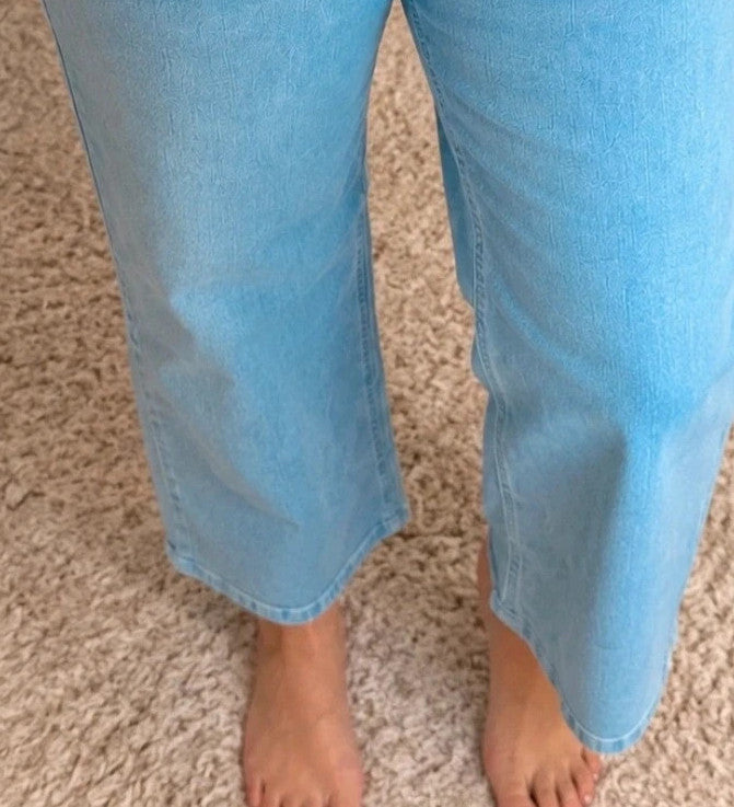 Rainbow blue straight jeans with unique overlapping waistband and two-button closure.