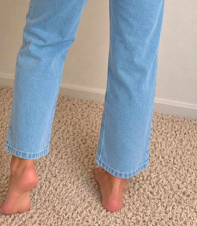 Rainbow blue straight jeans with unique overlapping waistband and two-button closure.