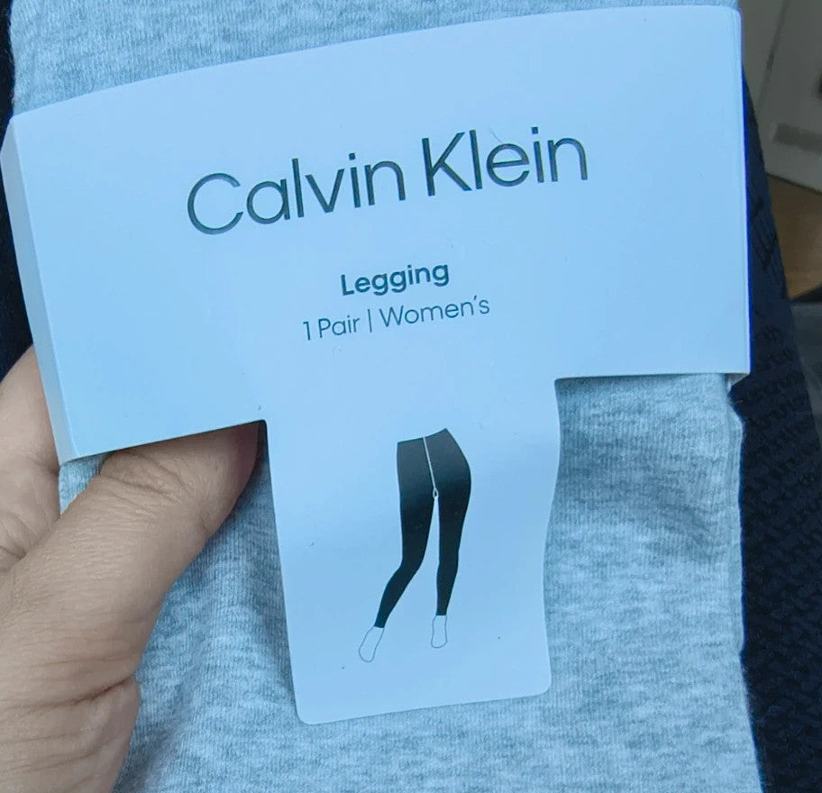 Calvin Klein grey bicycle tights with wide black logo waistband, fitted design.