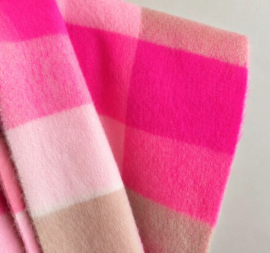 XXL oversized shawl in pink, cream, and beige with large check pattern and fringes.
