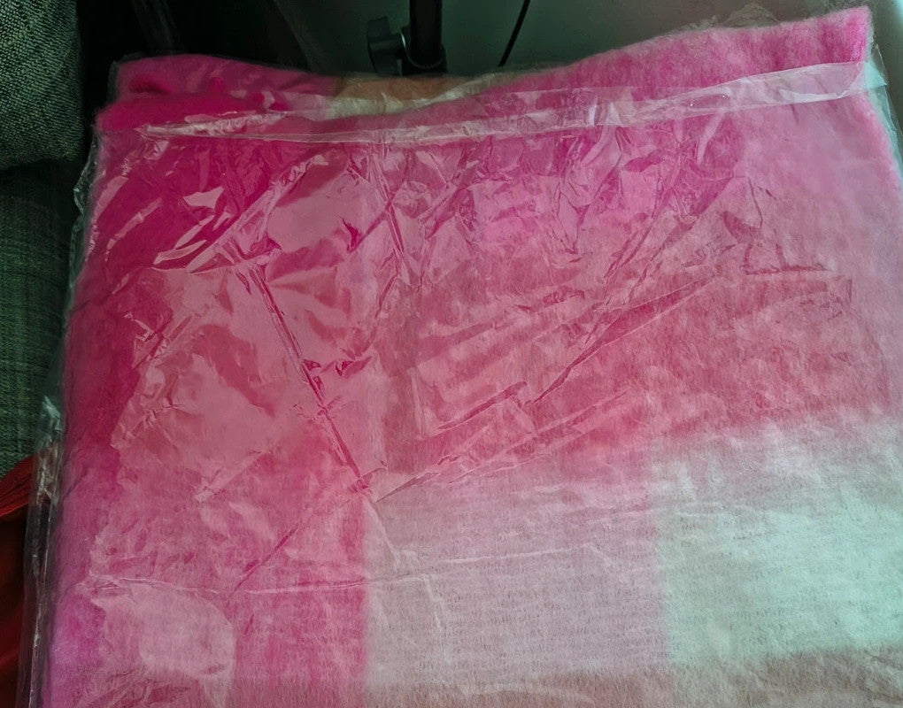 XXL oversized shawl in pink, cream, and beige with large check pattern and fringes.