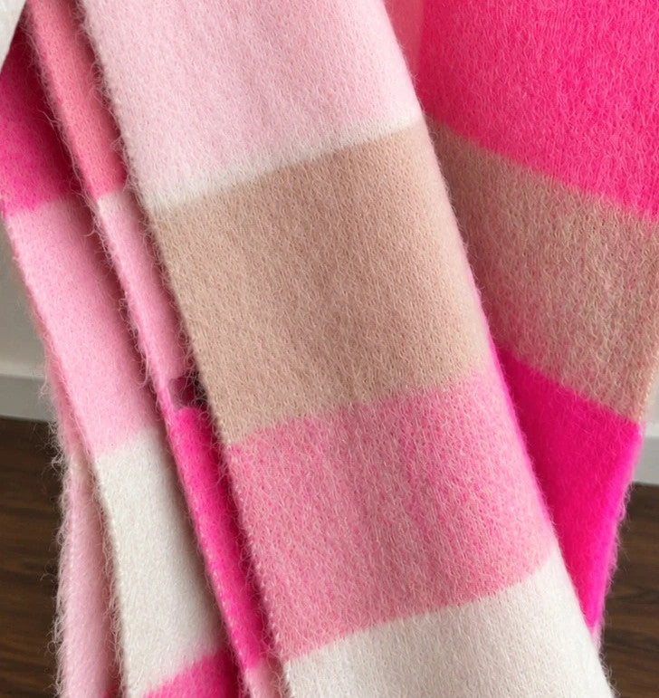 XXL oversized shawl in pink, cream, and beige with large check pattern and fringes.