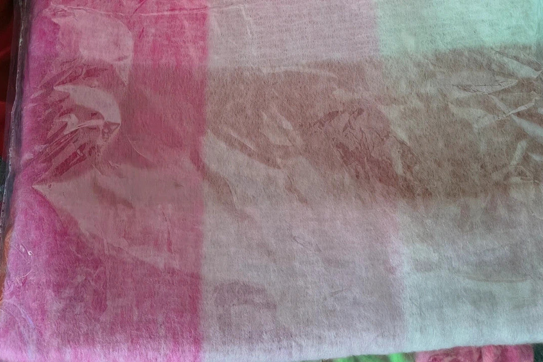 XXL oversized shawl in pink, cream, and beige with large check pattern and fringes.
