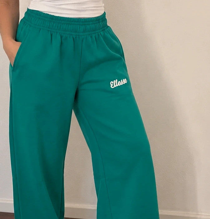 Ellesse green wide-leg jogging pants with logo, elastic waistband, and side pockets.